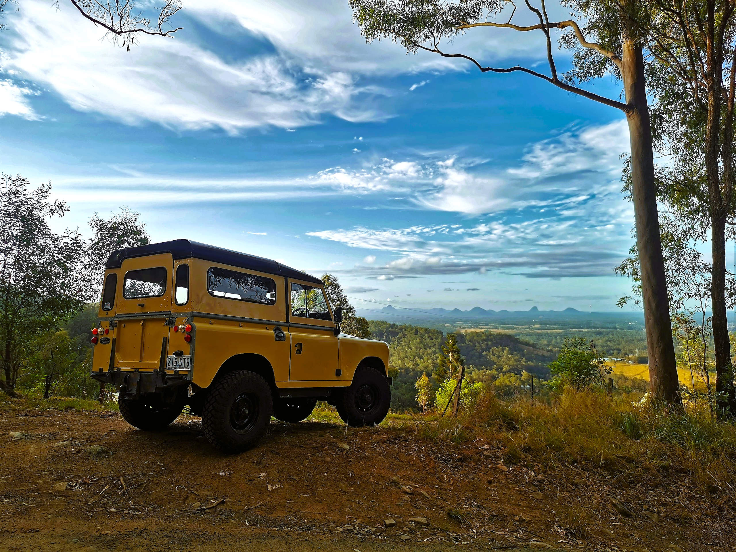 The 1973 electric Land Rover at a scenic spot overlooking Moreton Bay and the Glasshouse Mountains.