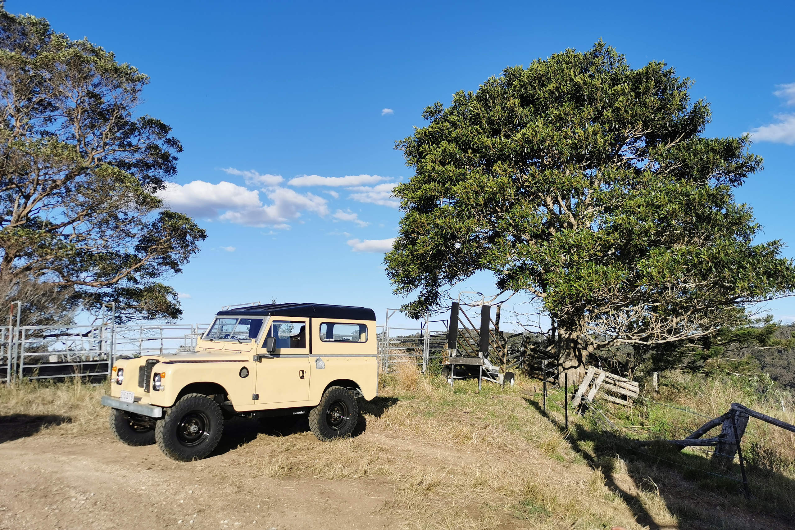 The electric 1973 Series 2 Land Rover at a scenic spot during a 4WD adventure.