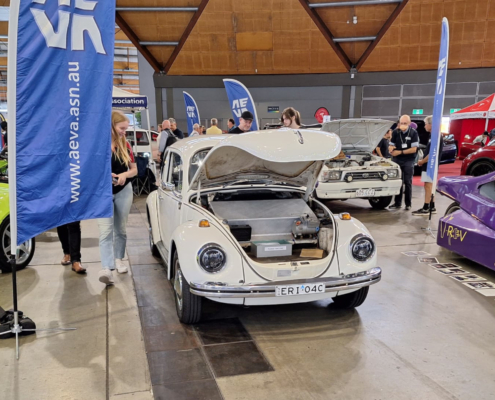 Front view of the 1971 Electric Super Beetle at the AEVA Sydney exhibition in 2024 with its battery box under the bonnet.